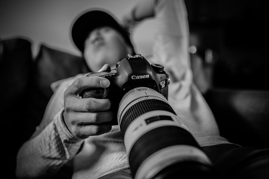 man holding Canon DSLR camera, photographer, person, human, electronics HD wallpaper
