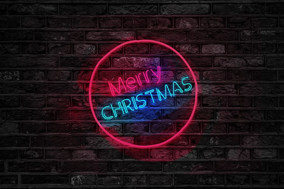 Turned on Red and Blue Merry Christmas Neon Sign, brick wall