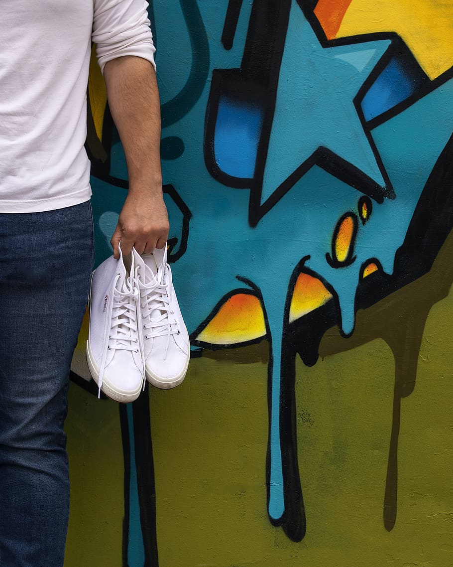 White shoes next to graffiti wall, clean, williamsburg, art wall