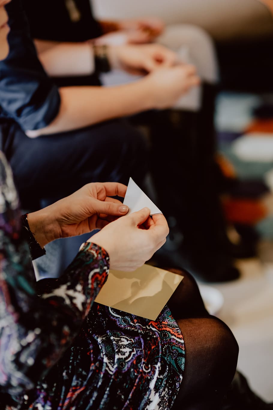 Women folding sheet of paper while making origami, creative, workshop HD wallpaper