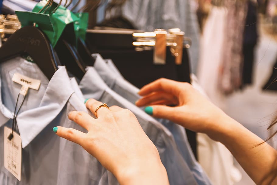 Woman chooses clothes in a store, shopping, human hand, women