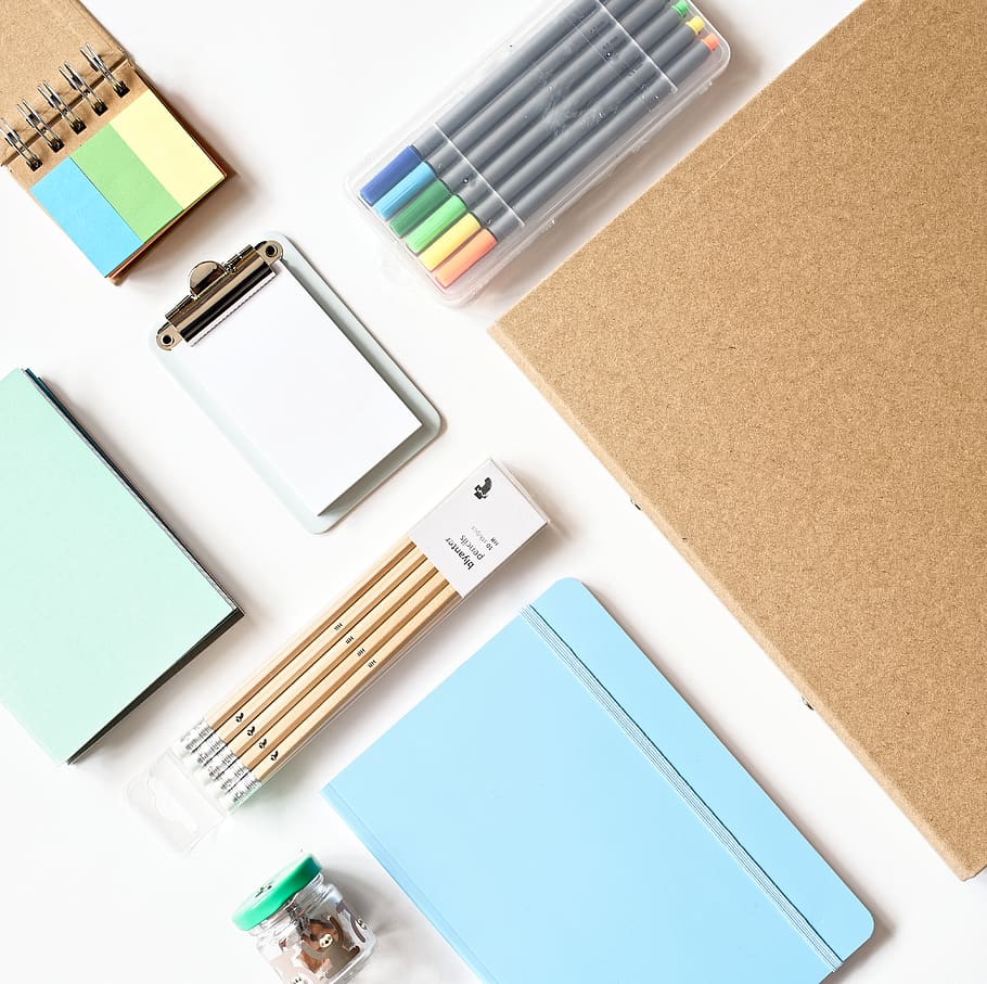 Sky-blue Scrapbook Near Beige Pen Both on White Wooden Surface HD wallpaper