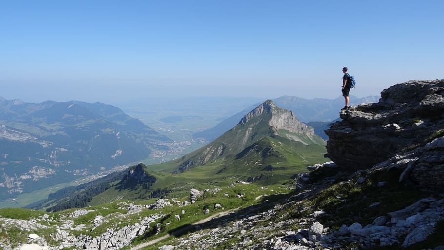 man standing near cliff facing mountains, beauty in nature, scenics - nature HD wallpaper