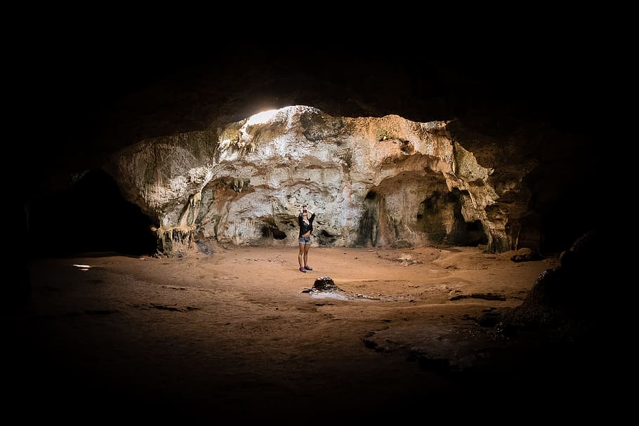 person standing in cave, rock, light, rock formation, sand, figure HD wallpaper