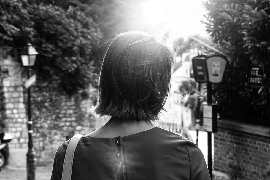 woman walking towards street light post, female, sunlight, black and white, HD wallpaper