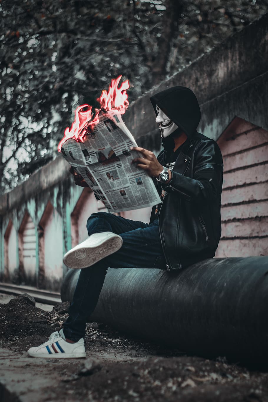 HD wallpaper: Man Wearing Mask Sitting Down and Holding Newspaper With Fire  | Wallpaper Flare
