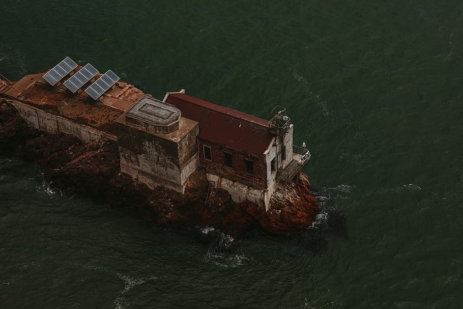 brown building with solar panel on top, water, waterfront, sea HD wallpaper
