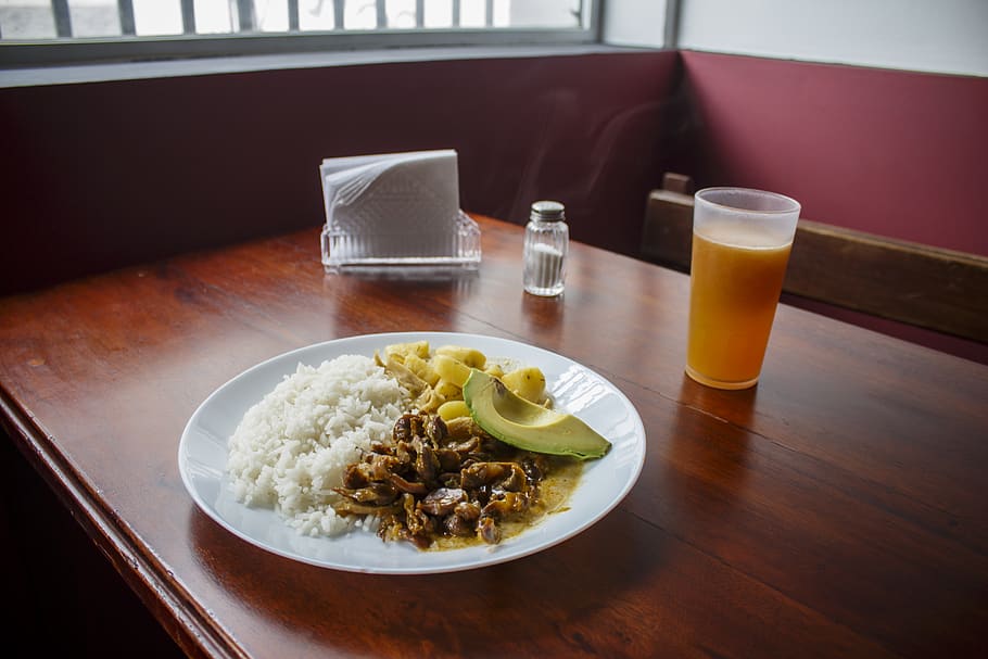 Plate of Cooked Rice With Cooked Beef Beside of Cup of Juice HD wallpaper