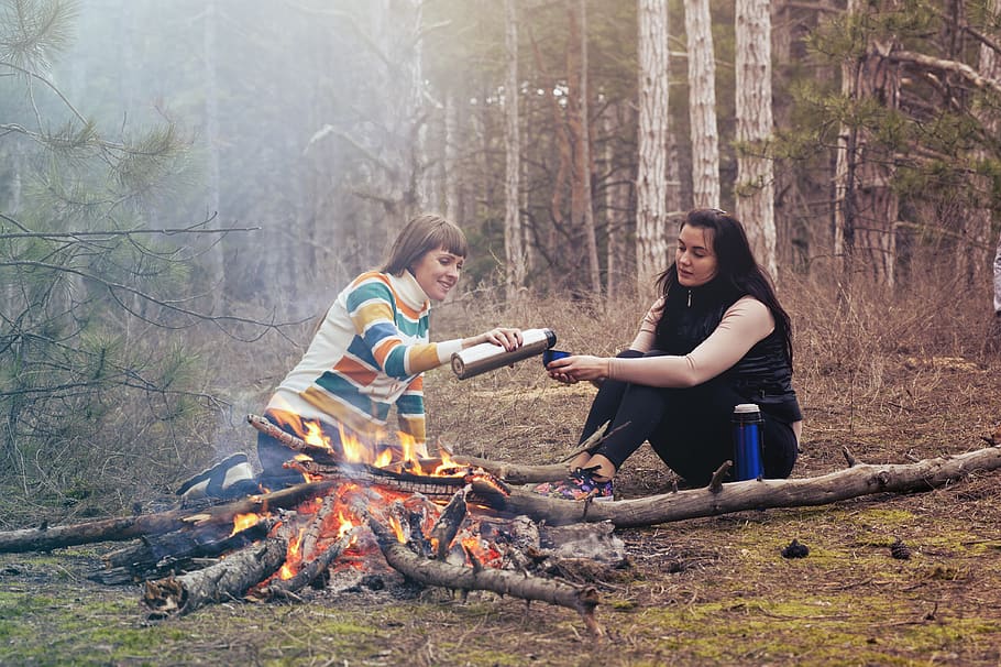 Two Women Sitting in Front of Burning Firewood, activity, adult