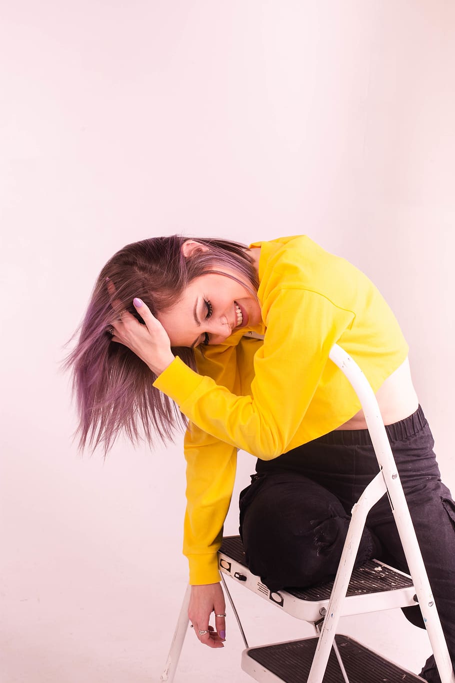 Woman in Yellow Long-sleeved Shirt Standing and Flipping Her Hair