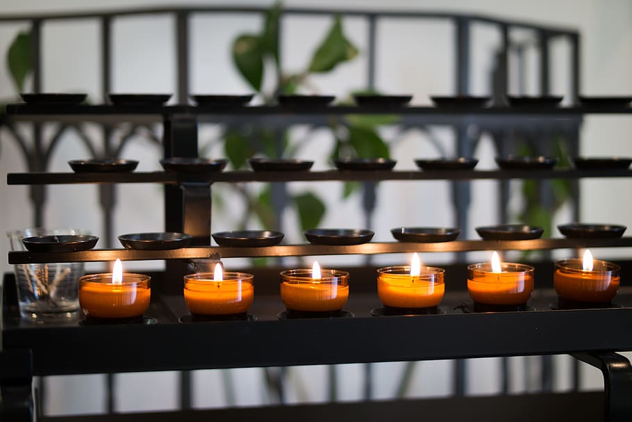 Close Up Photography of Tealight Candles on Black Metal Rack HD wallpaper