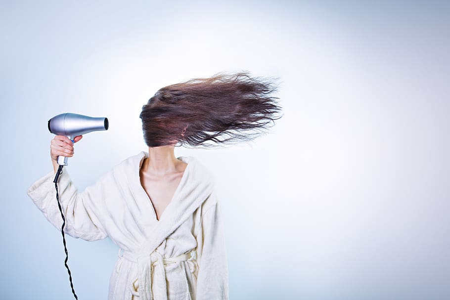 Woman Holding Gray Hair Dryer and Wearing White Bathrobe, barber