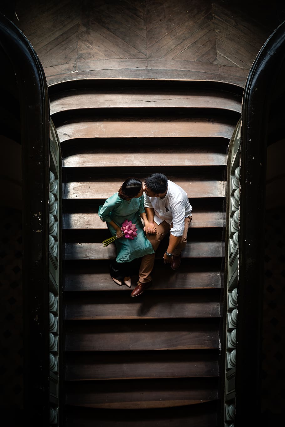 couple sitting on stairs, banister, handrail, human, person, staircase