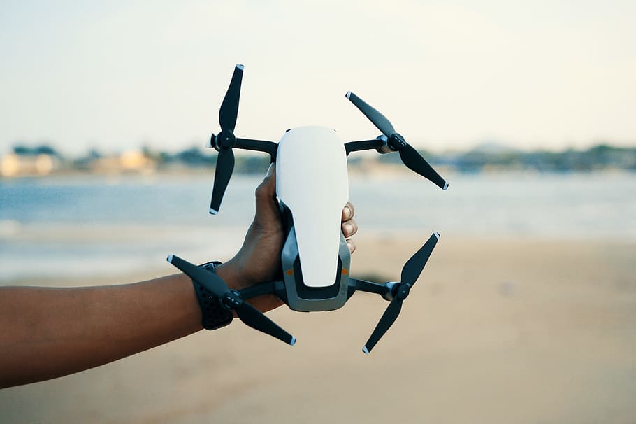 Person Holding White And Black Quadcopter Drone, camera, macro HD wallpaper