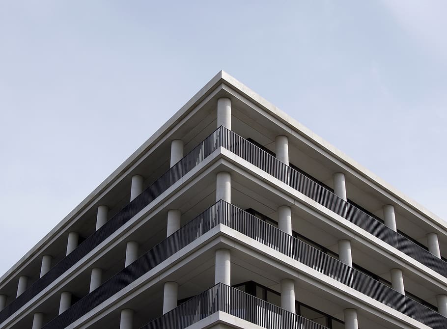 low-angle photography of white and gray concrete multi-story building under clear sky during daytime
