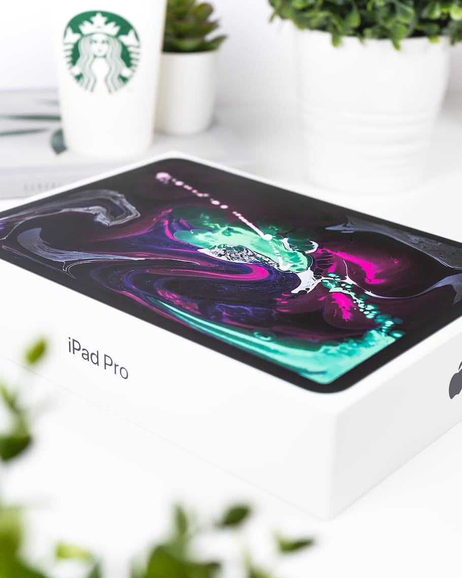 white and black iPad Pro box, no people, indoors, close-up, focus on foreground HD wallpaper