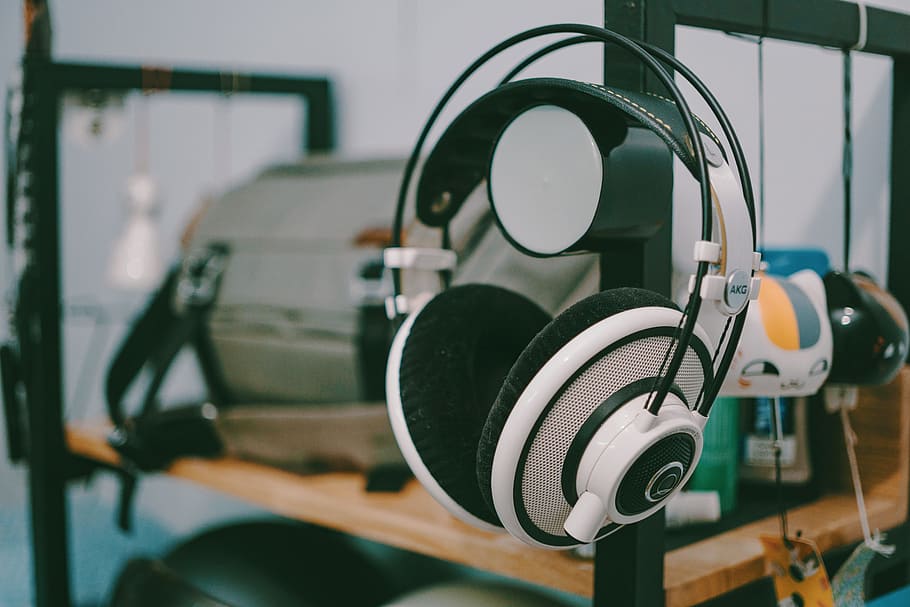 White And Black Wireless Headphones, hanging, indoors, focus on foreground HD wallpaper