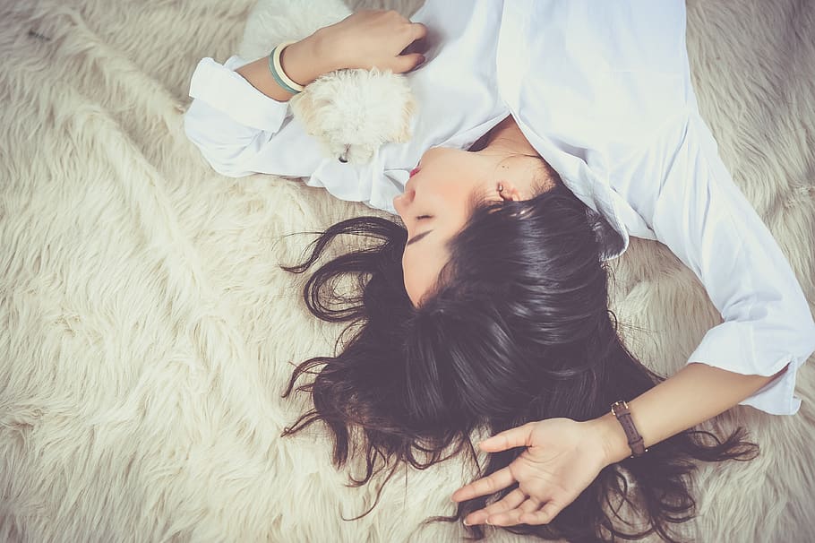 Woman Lying on Beige Faux-fur Mat, bed, cute, dog, female, girl, HD wallpaper