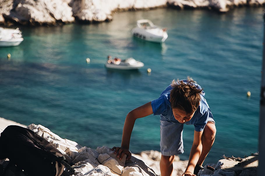boy climbing on rock, water, one person, real people, leisure activity HD wallpaper