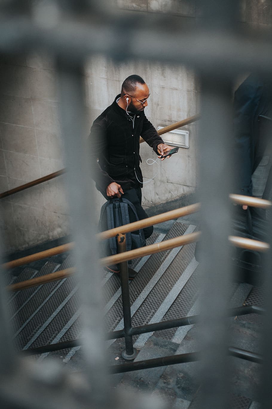 man on stairs while using smartphone and carrying backpack, one person HD wallpaper