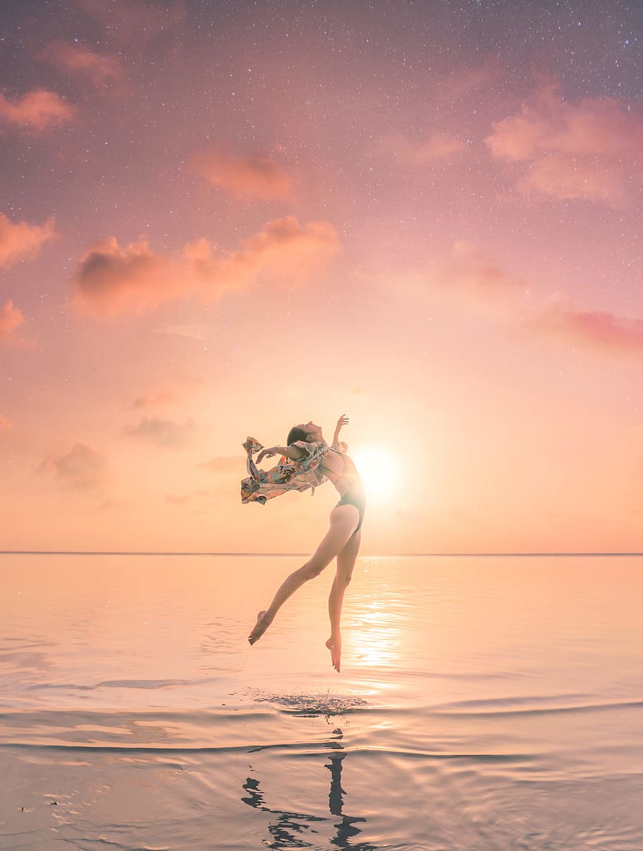 woman jumping on body of water, dream, sunlight, dance, sunset HD wallpaper
