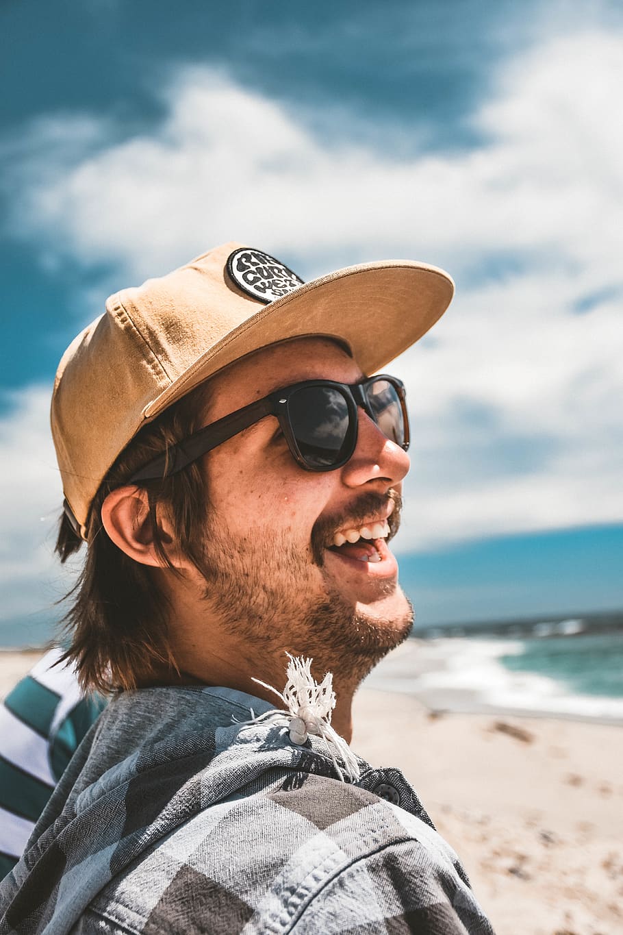 Man in Black and Brown Long Sleeve Shirt Wearing Black Sunglasses with  Black Sun Visor Hat · Free Stock Photo