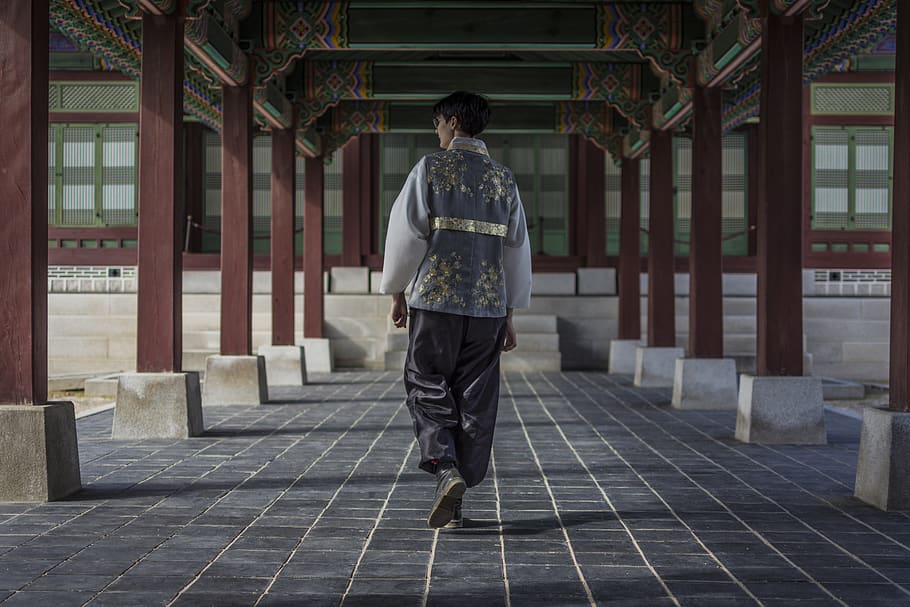 man walking under the building, person, human, clothing, apparel HD wallpaper