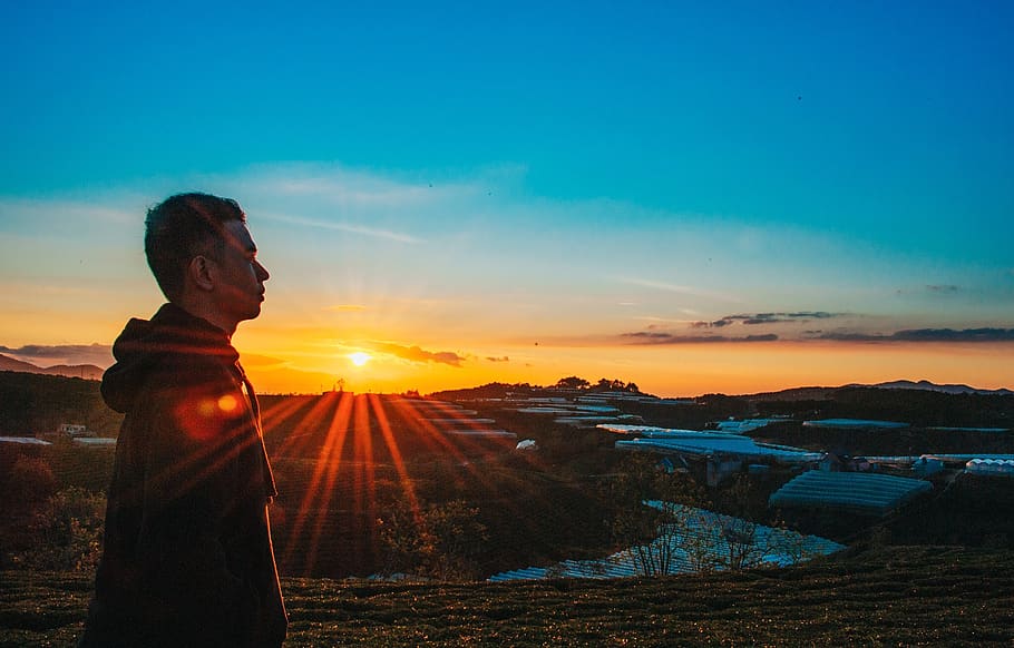 Photo of a Man Wearing Hoodie During Sunset, backlit, dawn, environment HD wallpaper