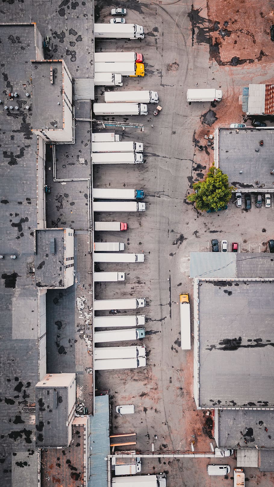 aerial view of trucks on gray commercial building during daytime, HD wallpaper