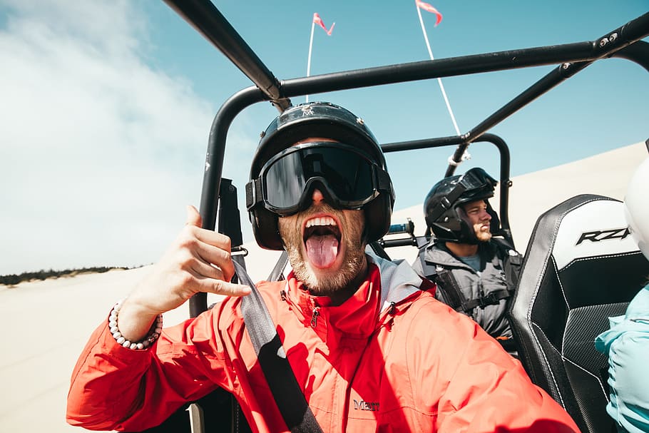 man showing his tongue while riding on ATV, dune buggy, helmet, HD wallpaper