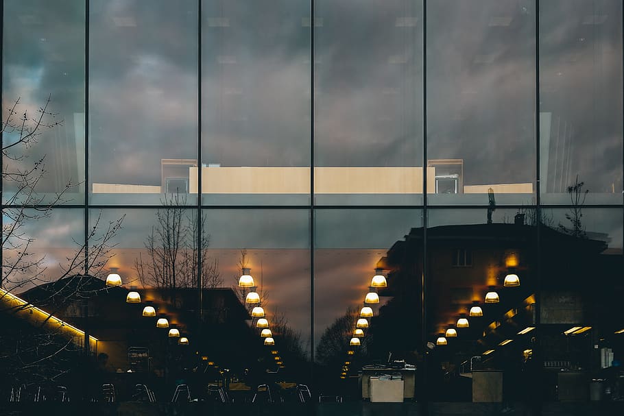 Reflection of Street Lights from Window of Building during Nighttime HD wallpaper