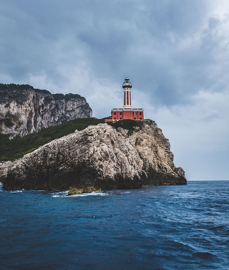 Red Lighthouse on Top of Hills Beside Sea, architecture, beach HD wallpaper