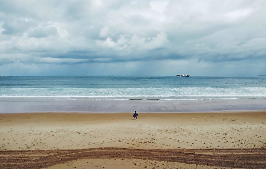 Person Walking on Sand Near Body of Water, beach, clouds, daylight HD wallpaper