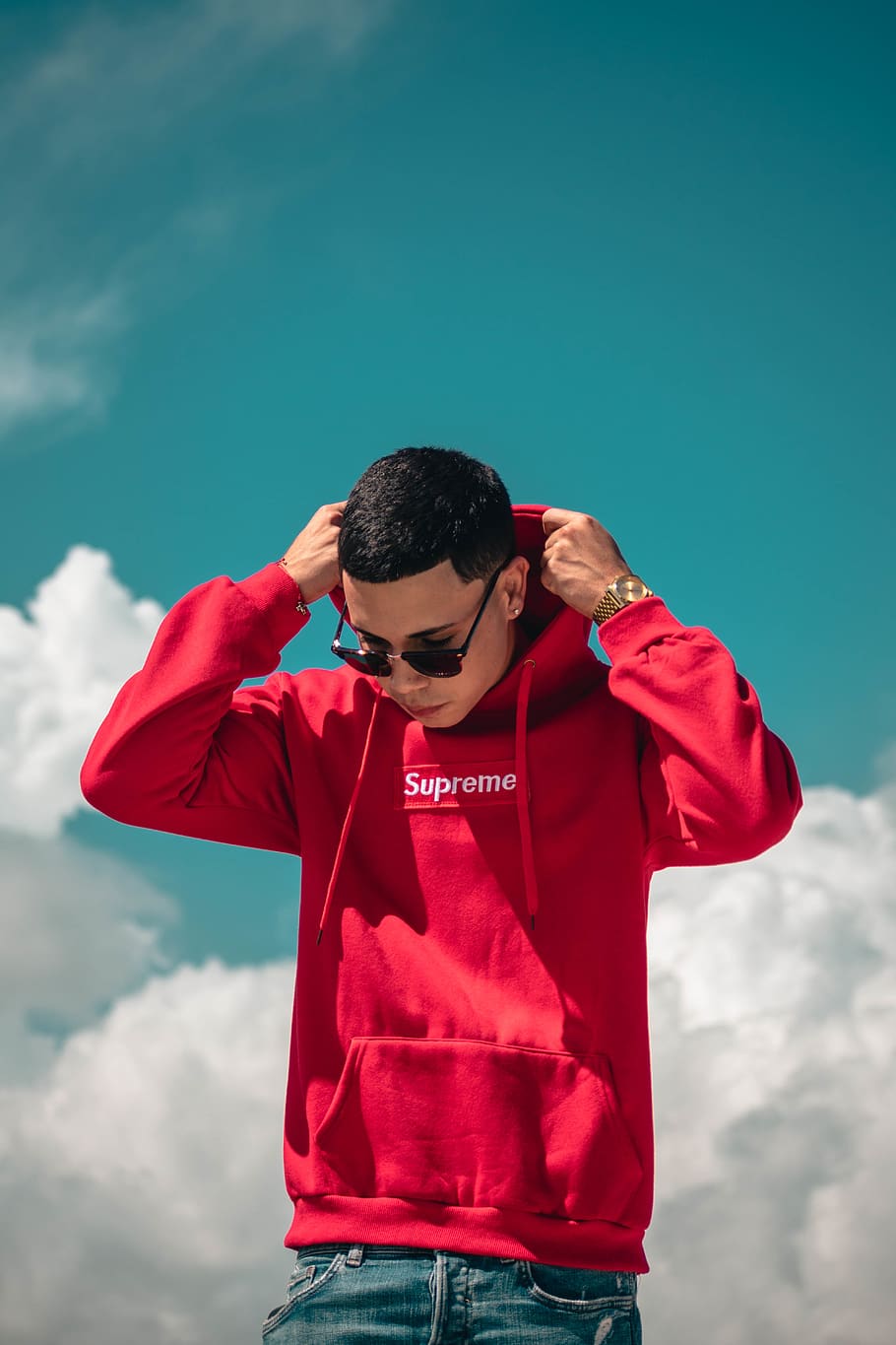 Download Hd Wallpaper Man Wearing Red Supreme Pullover Hoodie Sky Front View One Person Wallpaper Flare