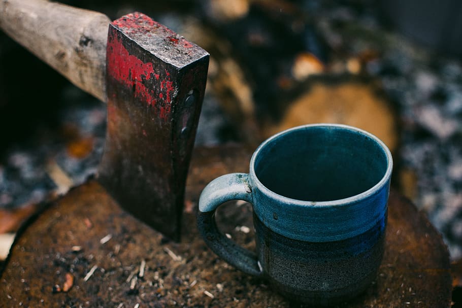 brown handled axe near gray and black ceramic cup, mug, rustic