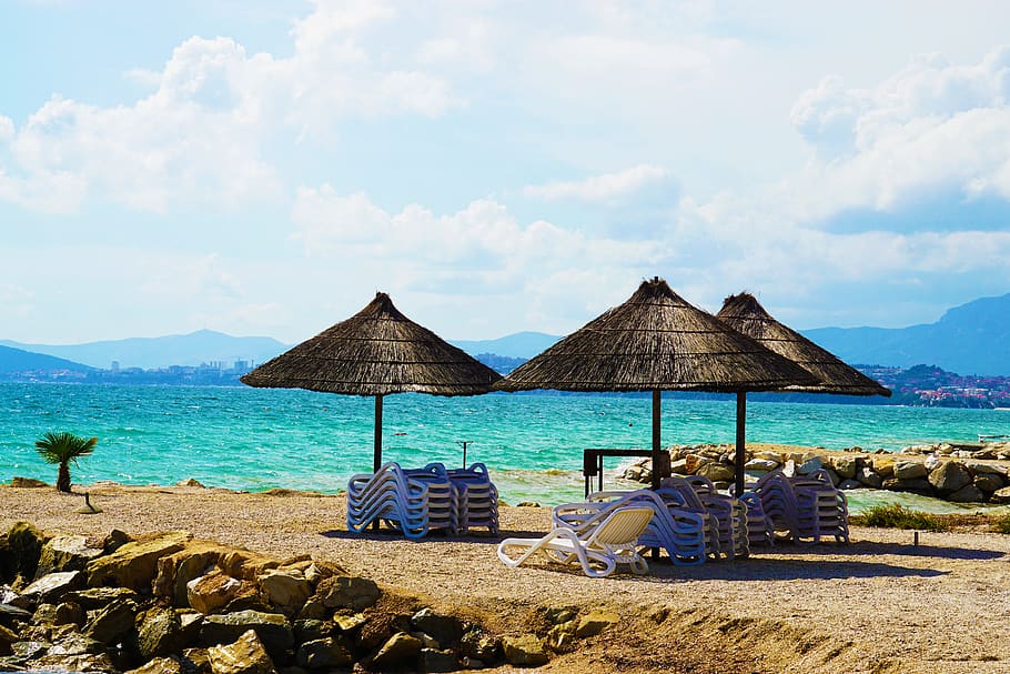 Three Brown Parasols on Seashore, beach, beach chairs, clouds HD wallpaper