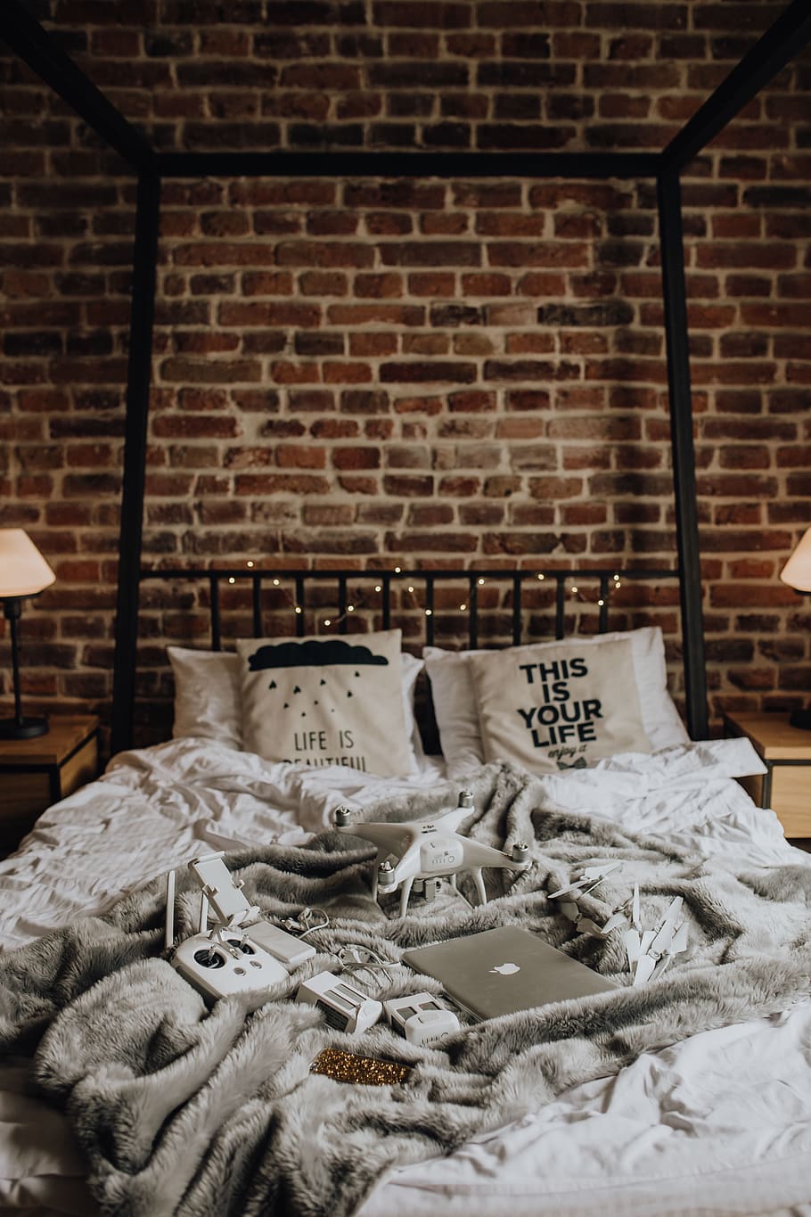 Drone, laptop and accessories lie on the bed ready for travel HD wallpaper