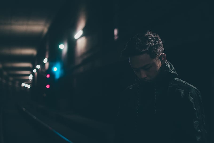 close-up photo of man in black jacket standing inside tunnel, HD wallpaper