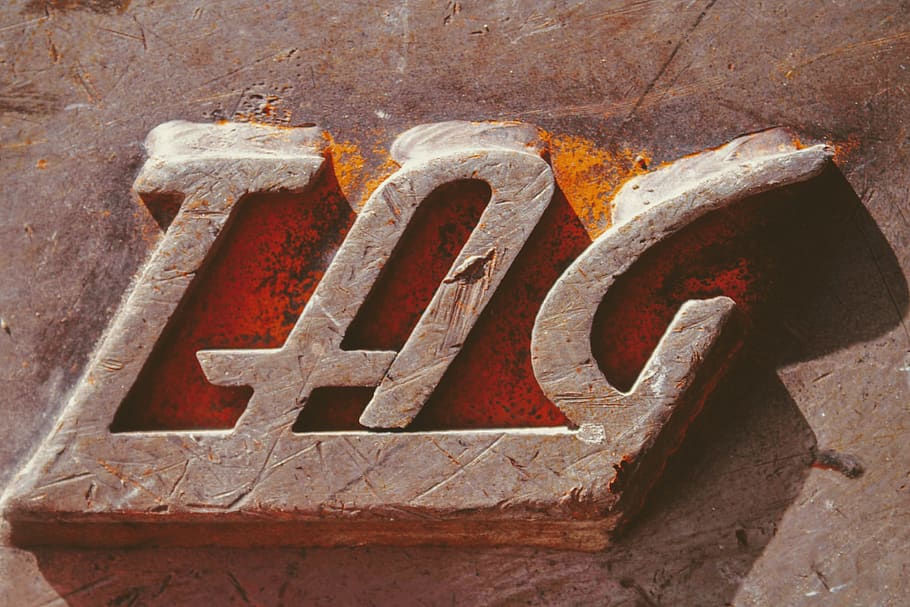 TAG emboss, rust, text, letter, word, metal, shadow, iron, sunlight HD wallpaper