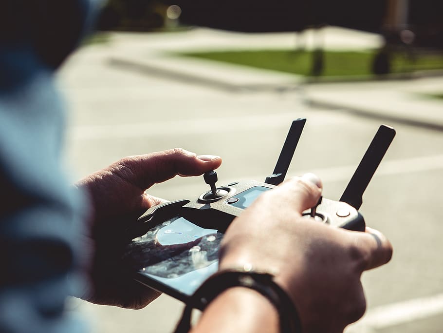 Man Controlling Drone With Remote, controller, dji, dji mavic pro HD wallpaper