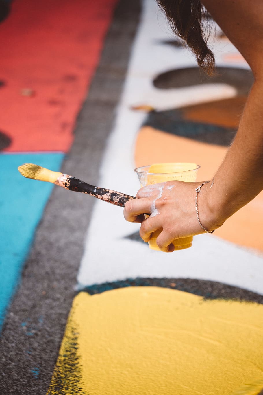 person holding cup with yellow paint and paintbrush, hand, vancouver HD wallpaper