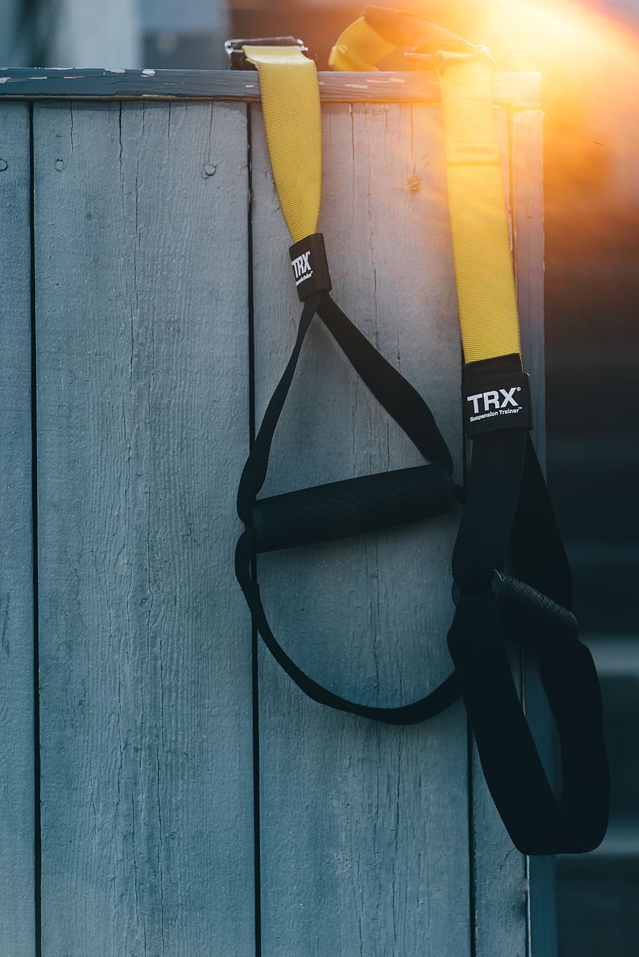 black and yellow TRX resistance band, communication, text, wood - material