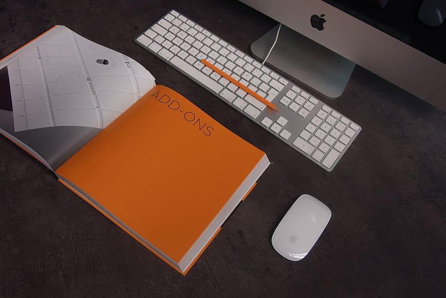 Orange Book in Distance With Silver Imac, apple, desk, keyboard HD wallpaper