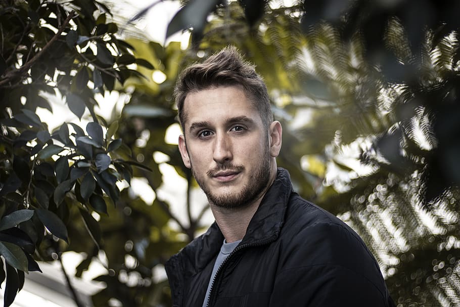 man smiling, portrait, headshot, looking at camera, plant, one person HD wallpaper