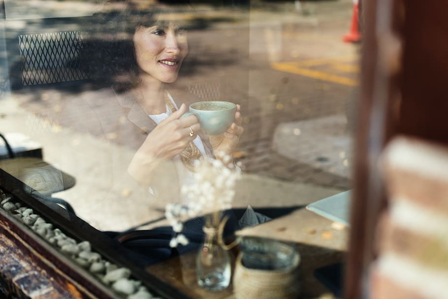 Woman Holding Teacup While Smiling, blur, close-up, coffee, coffee cup HD wallpaper