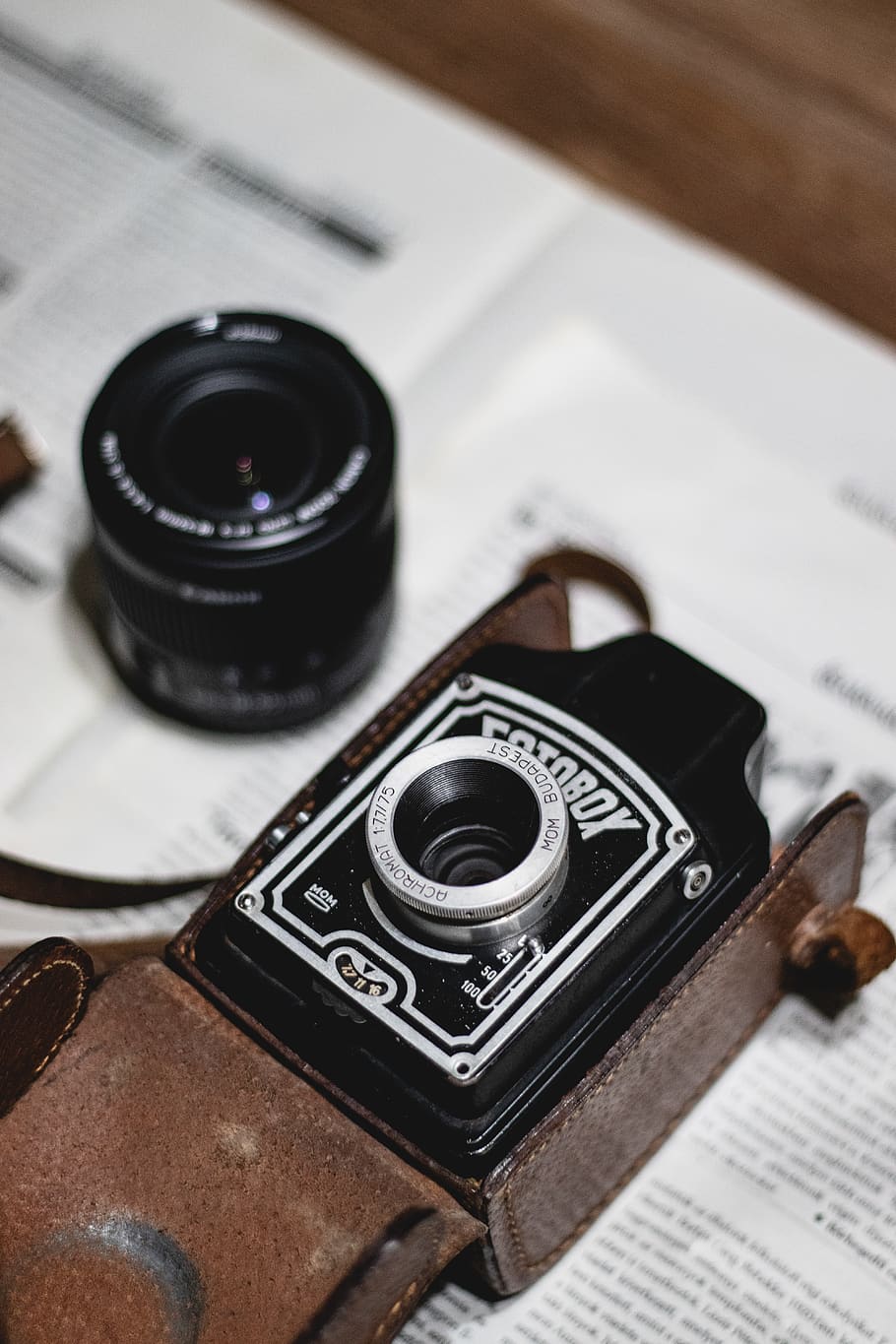 black and white land camera in brown leather case, electronics