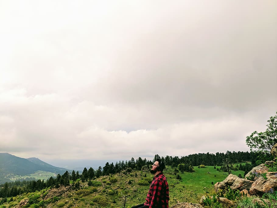 Man Wearing Red and Black Plaid Shirt Standing on Green Grass Hill HD wallpaper