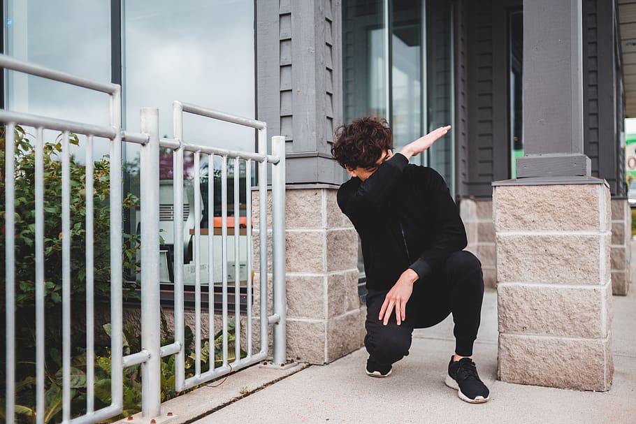 person seated near fence doing dab sign, real people, one person, HD wallpaper