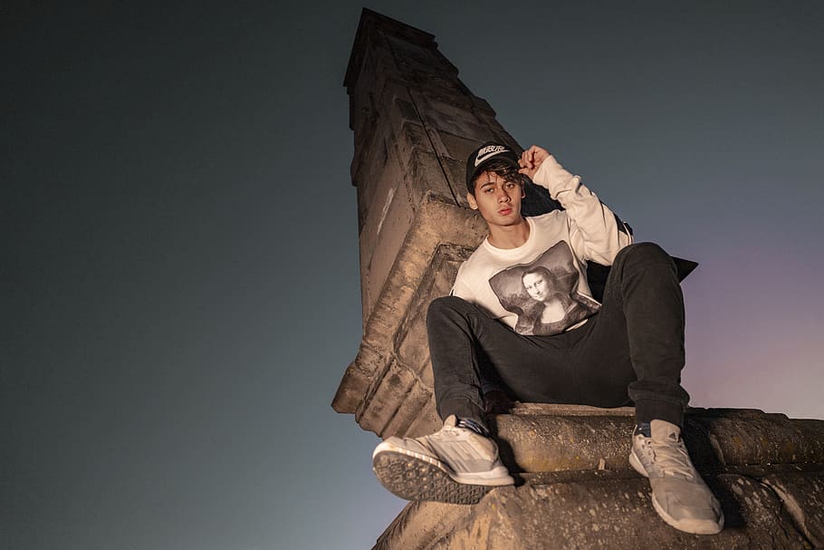 man sitting on statue, one person, front view, young adult, lifestyles HD wallpaper