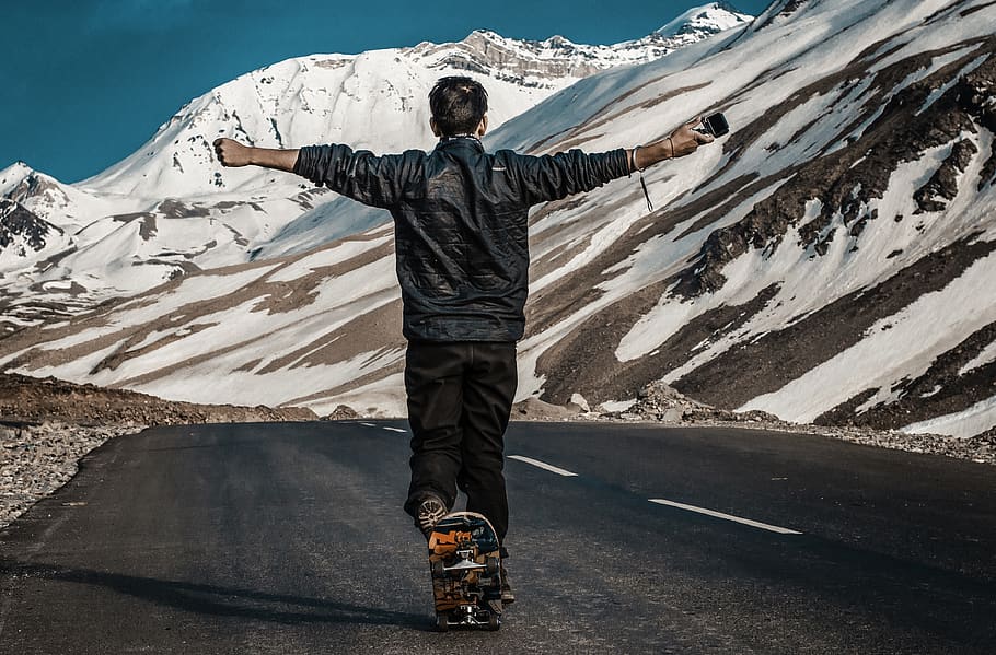 Photo of a Man I the Middle of Road Using Skateboard, asphalt HD wallpaper